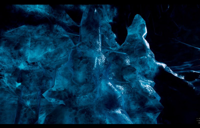 Close view of icy cave formations with bright blue surface patterns.